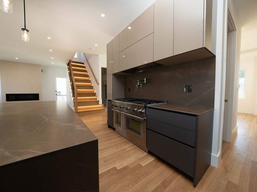 21 Cavanaugh Path Newton, MA 02459 - Photo 3 of 30 a kitchen with wooden cabinets and a stove top oven