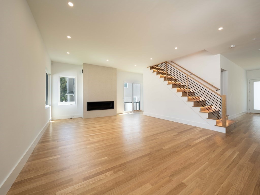21 Cavanaugh Path Newton, MA 02459 - Photo 5 of 30 a view of a livingroom with wooden floor and staircase