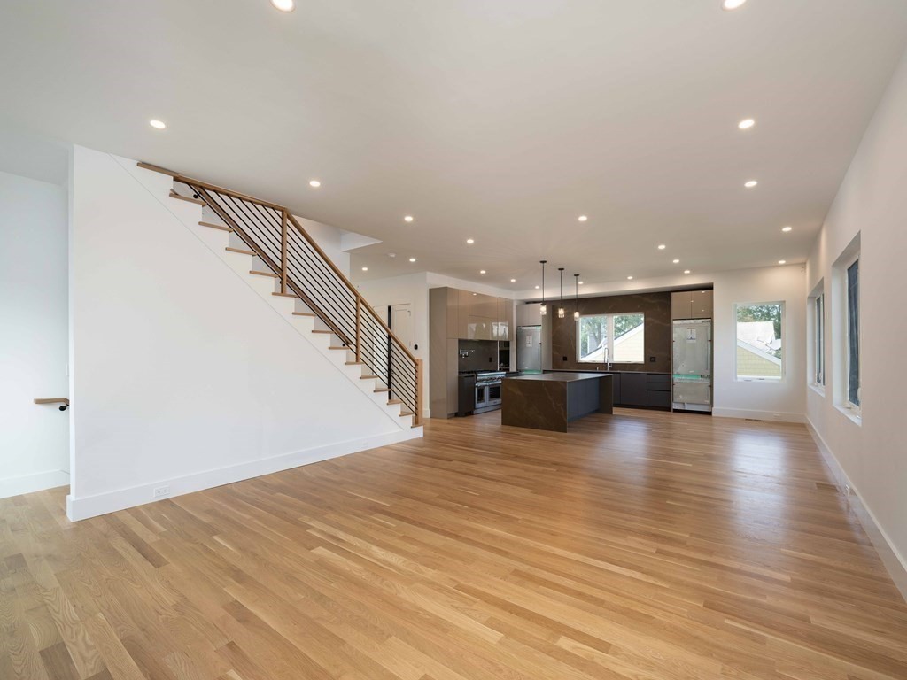 21 Cavanaugh Path Newton, MA 02459 - Photo 7 of 30 a view of a livingroom with a ceiling fan and kitchen view