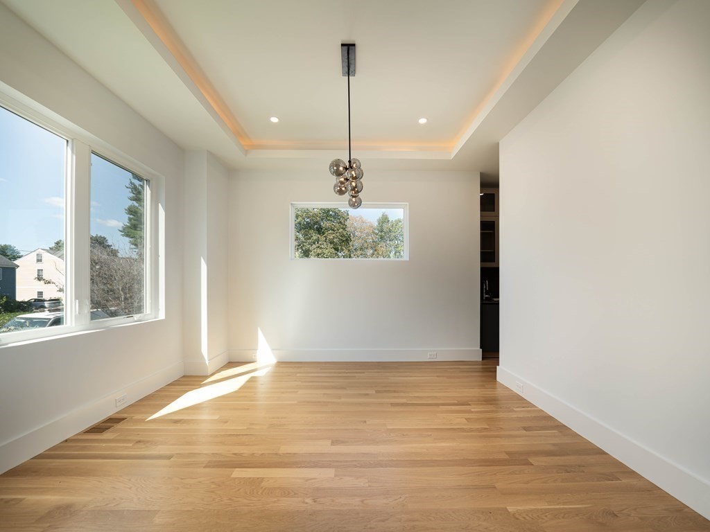 21 Cavanaugh Path Newton, MA 02459 - Photo 8 of 30 a view of a room with window wooden floor and chandelier