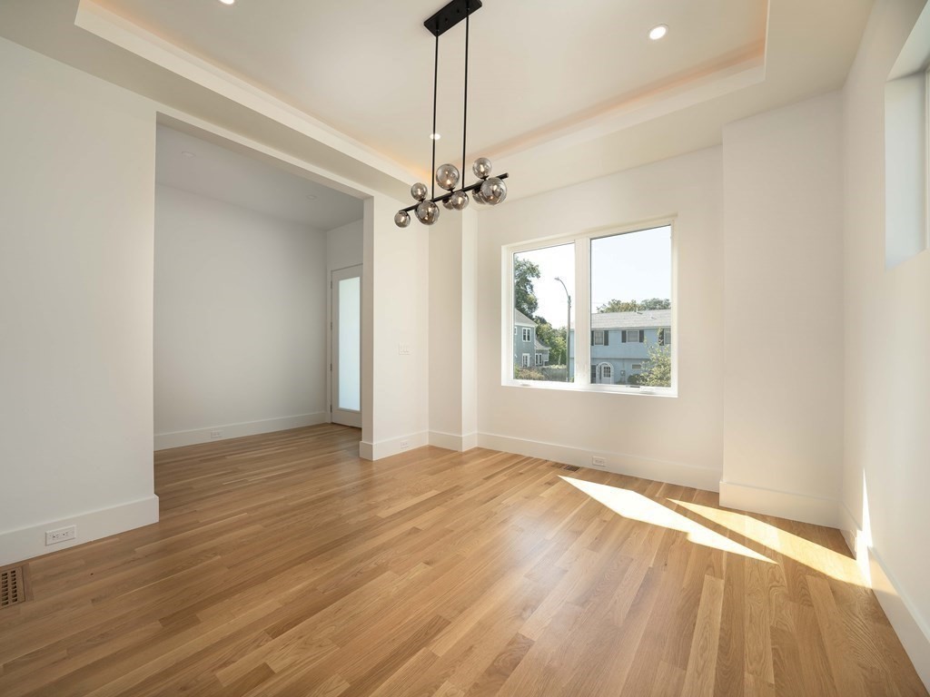 21 Cavanaugh Path Newton, MA 02459 - Photo 9 of 30 wooden floor in an empty room with a window