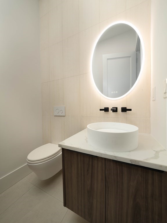 21 Cavanaugh Path Newton, MA 02459 - Photo 10 of 30 a bathroom with a sink a mirror and a toilet