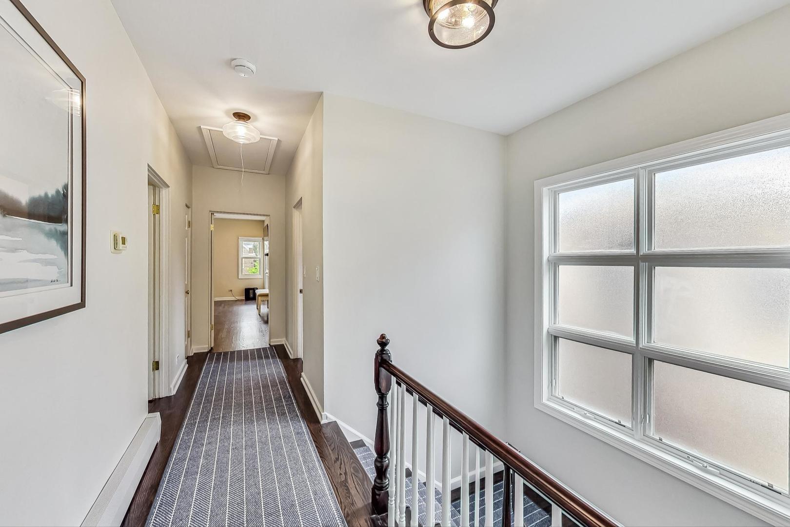 1701 Walnut Avenue Wilmette, IL 60091 - Photo 13 of 30 a view of a hallway view with wooden floor and staircase