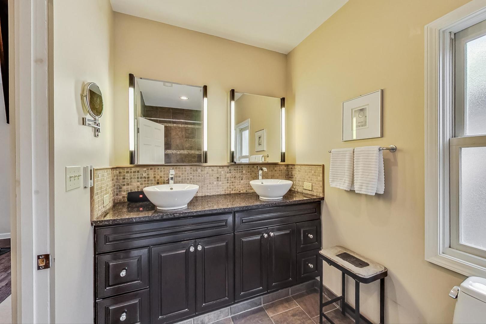 1701 Walnut Avenue Wilmette, IL 60091 - Photo 16 of 30 a bathroom with a granite countertop sink and a mirror