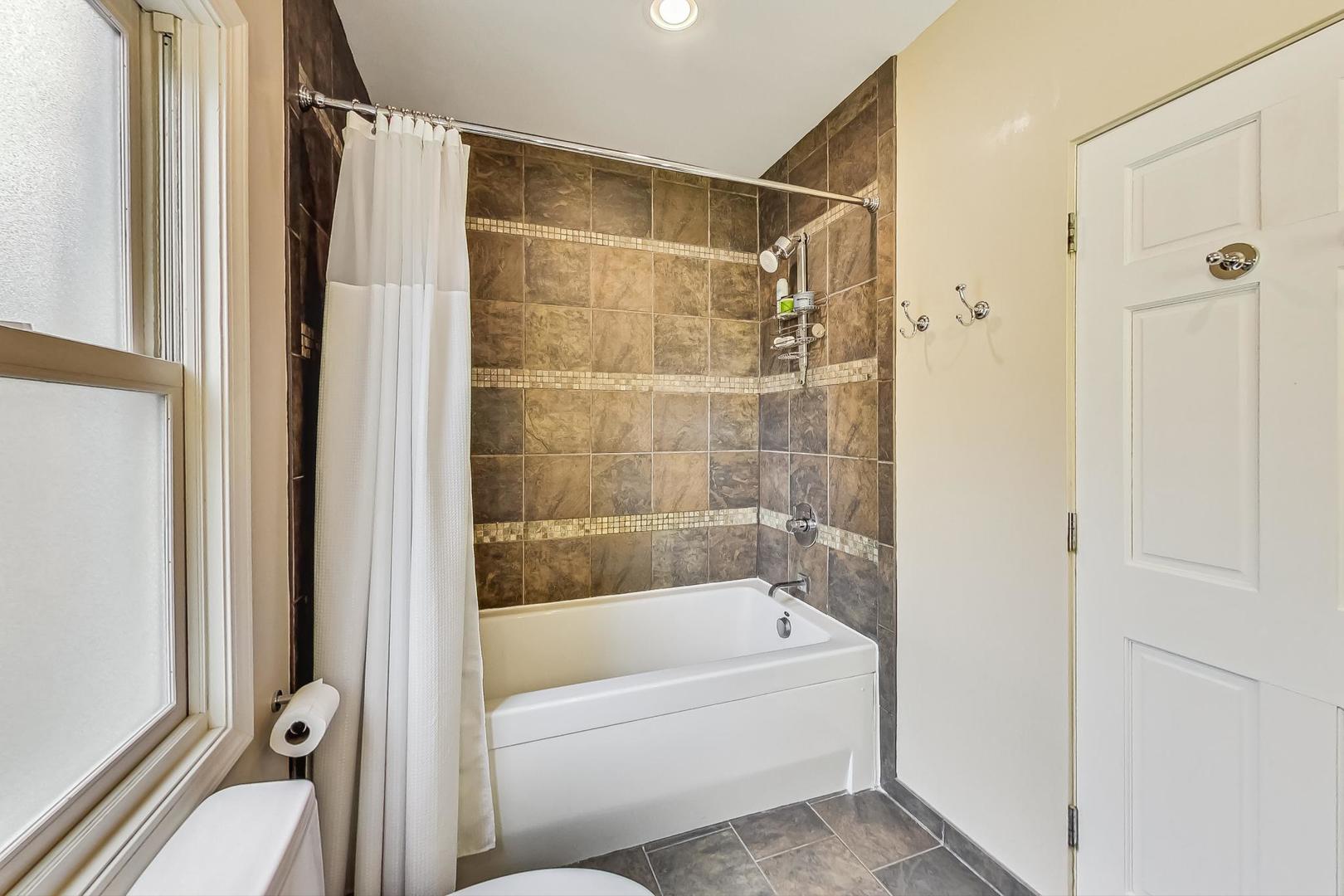 1701 Walnut Avenue Wilmette, IL 60091 - Photo 17 of 30 a bathroom with a bathtub and a shower