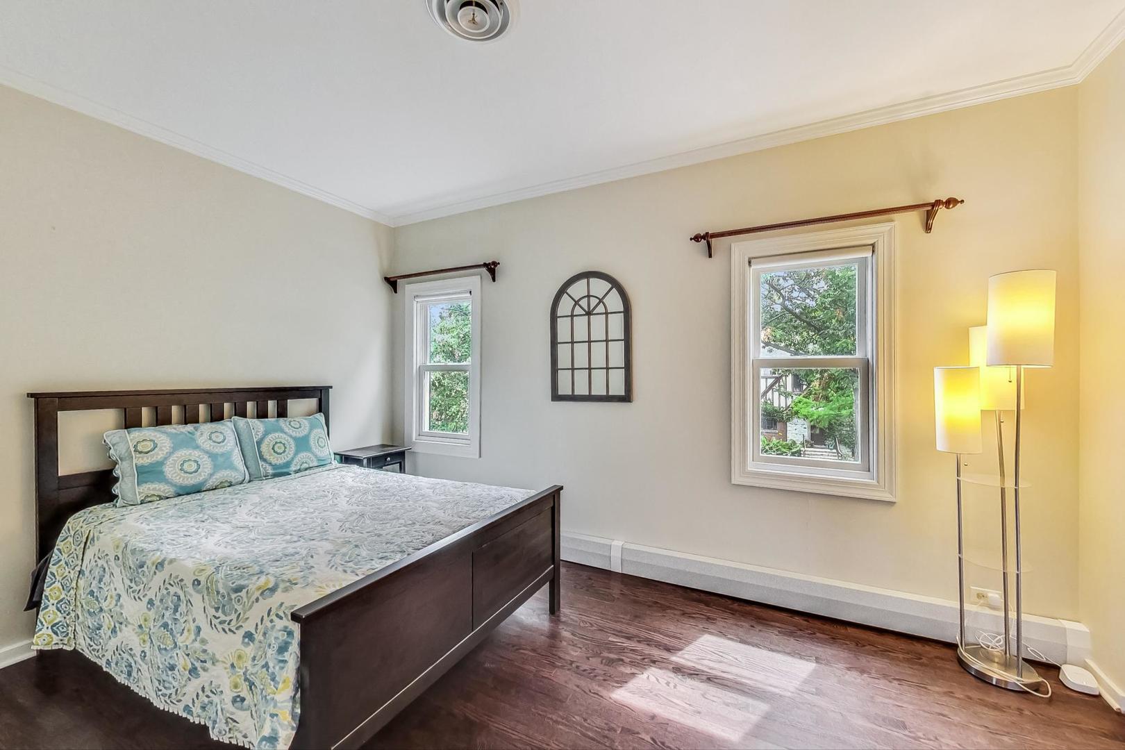 1701 Walnut Avenue Wilmette, IL 60091 - Photo 20 of 30 a bed sitting in a bedroom next to a window