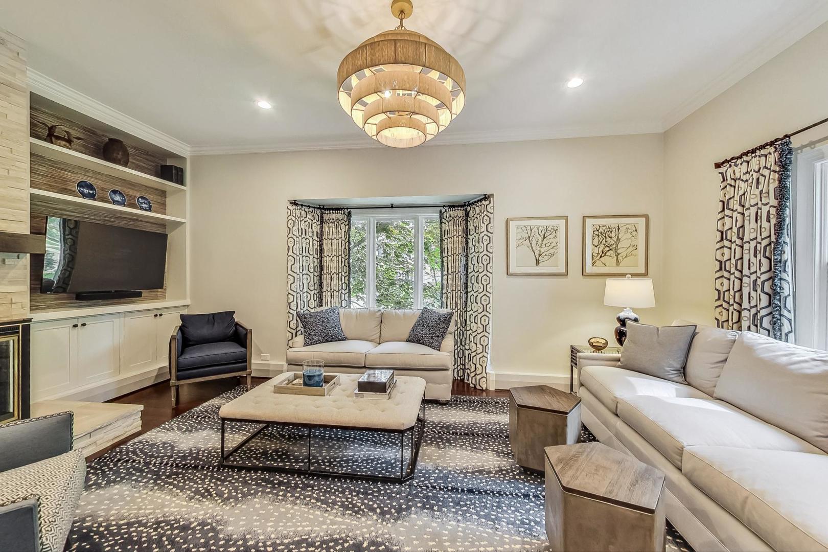 1701 Walnut Avenue Wilmette, IL 60091 - Photo 3 of 30 a living room with furniture a flat screen tv and a window