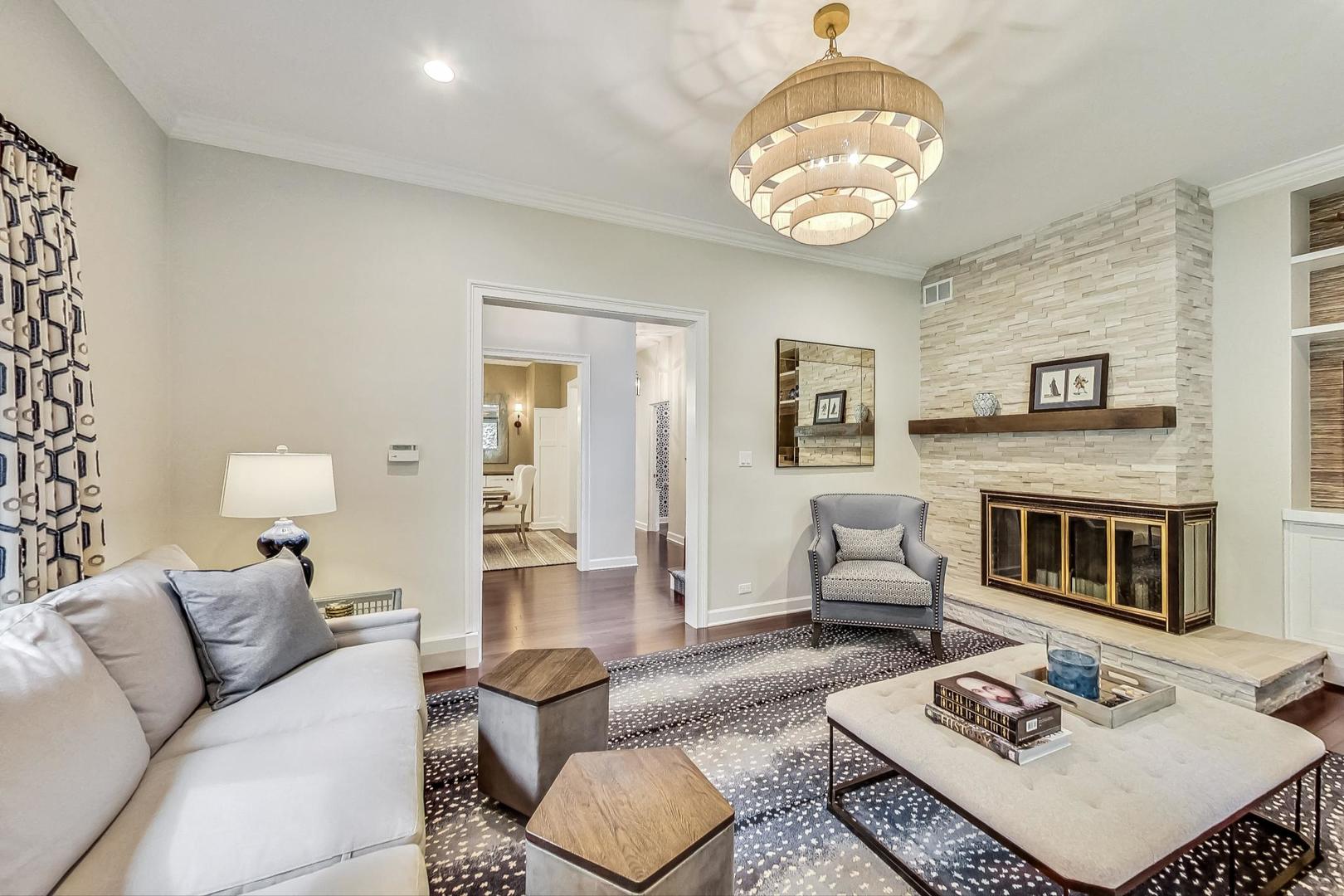 1701 Walnut Avenue Wilmette, IL 60091 - Photo 5 of 30 a living room with furniture a fireplace and a table