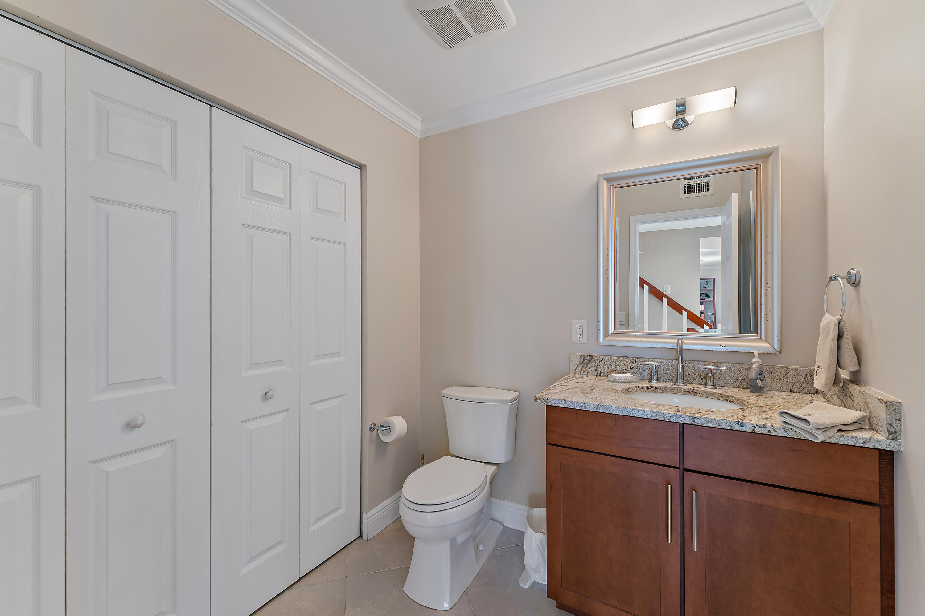 1420 Ocean Way, Unit 14C Jupiter, FL 33477 - Photo 16 of 41 a bathroom with a toilet a sink a vanity and mirror