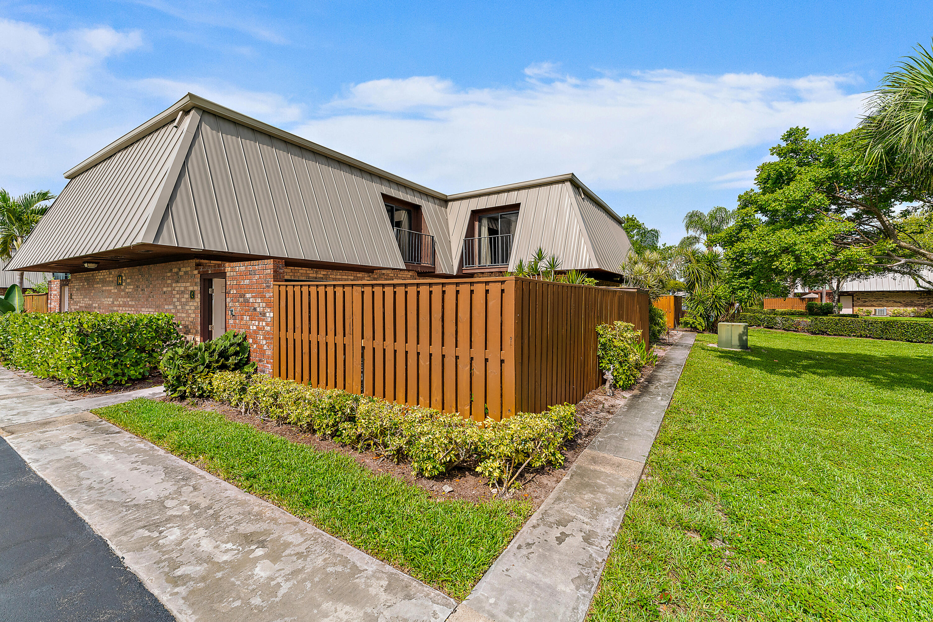 1420 Ocean Way, Unit 14C Jupiter, FL 33477 - Photo 2 of 41 a front view of house with garden