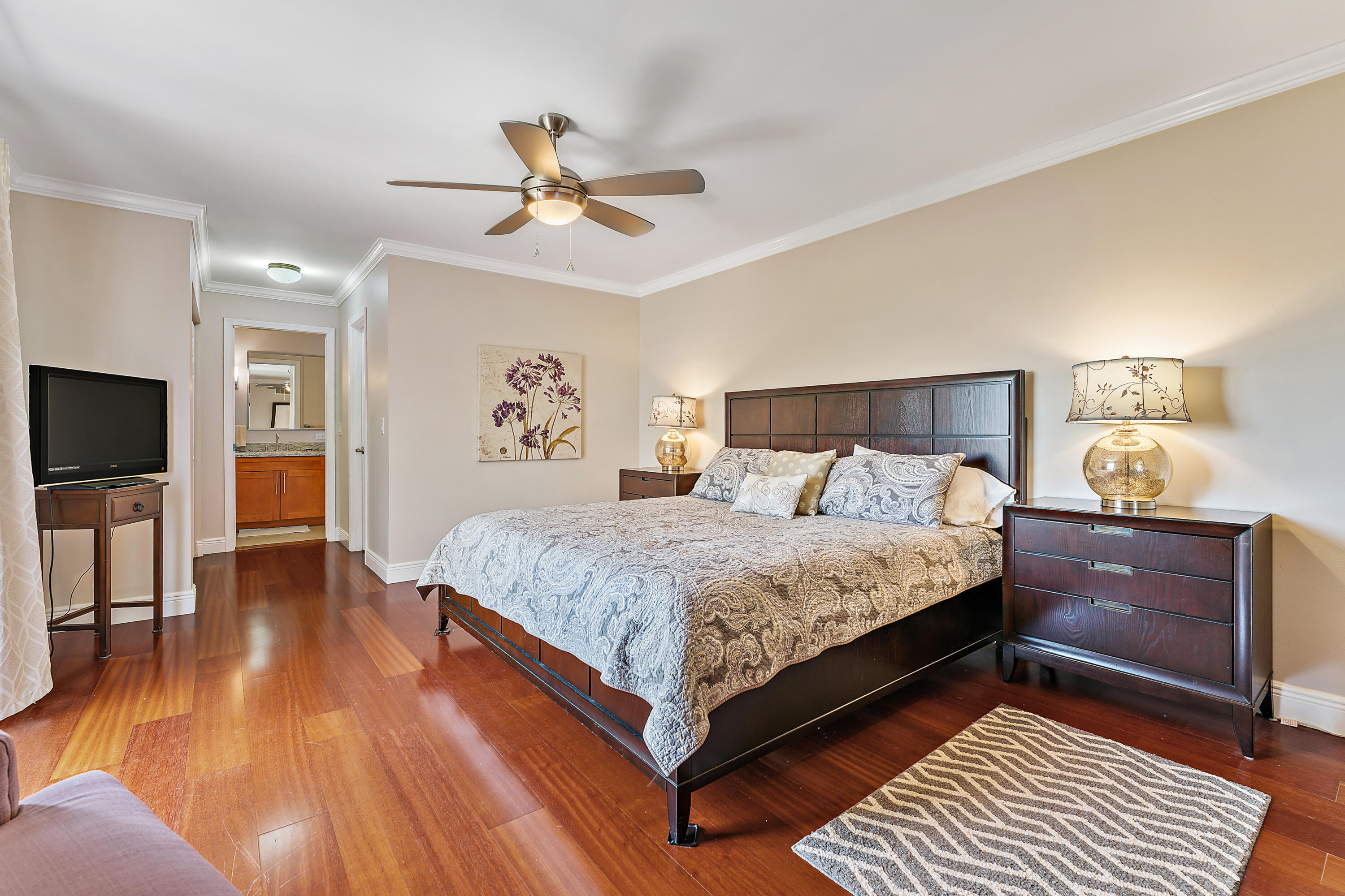 1420 Ocean Way, Unit 14C Jupiter, FL 33477 - Photo 25 of 41 a bedroom with a large bed and a chandelier