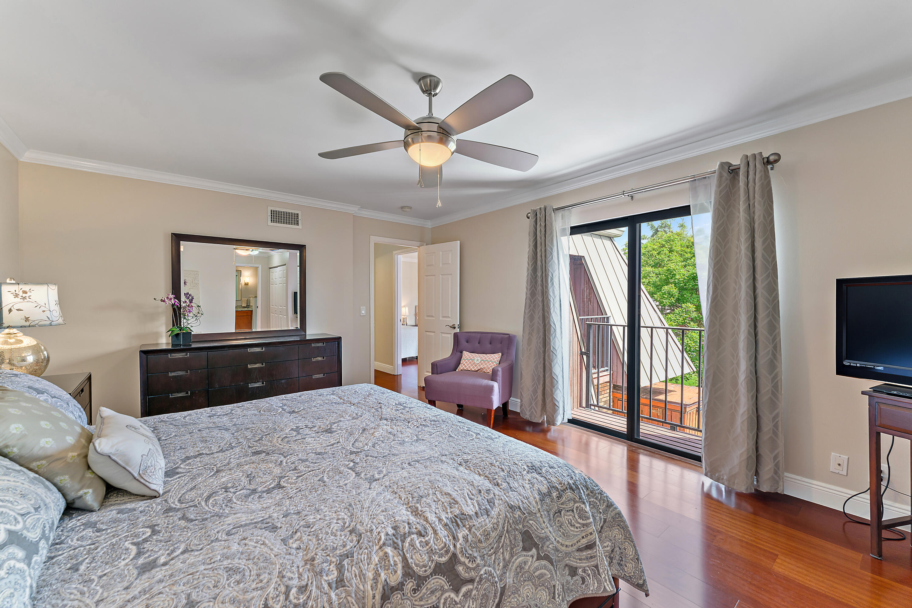 1420 Ocean Way, Unit 14C Jupiter, FL 33477 - Photo 27 of 41 a bedroom with a bed and a flat screen tv