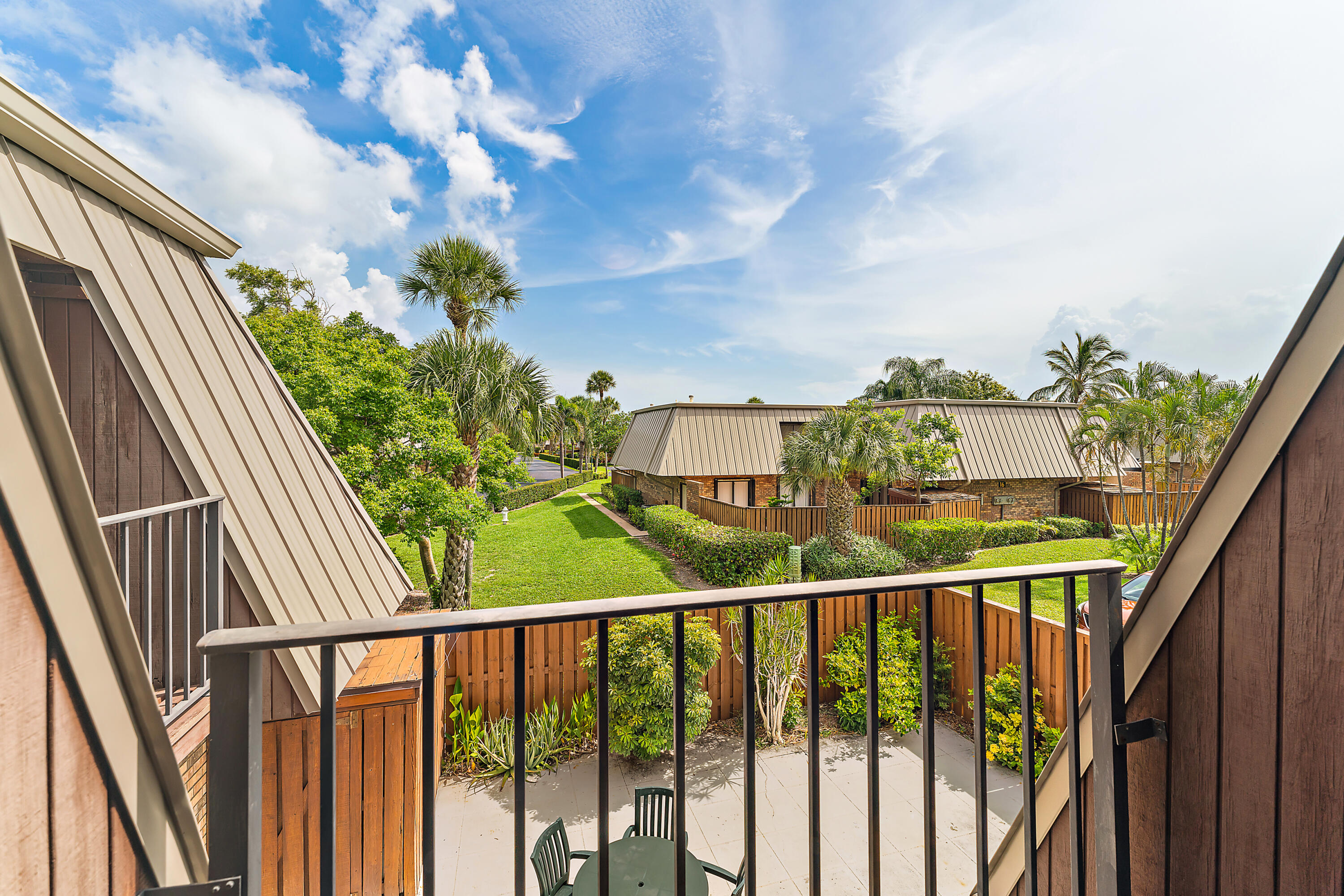 1420 Ocean Way, Unit 14C Jupiter, FL 33477 - Photo 30 of 41 a view of a balcony with wooden fence