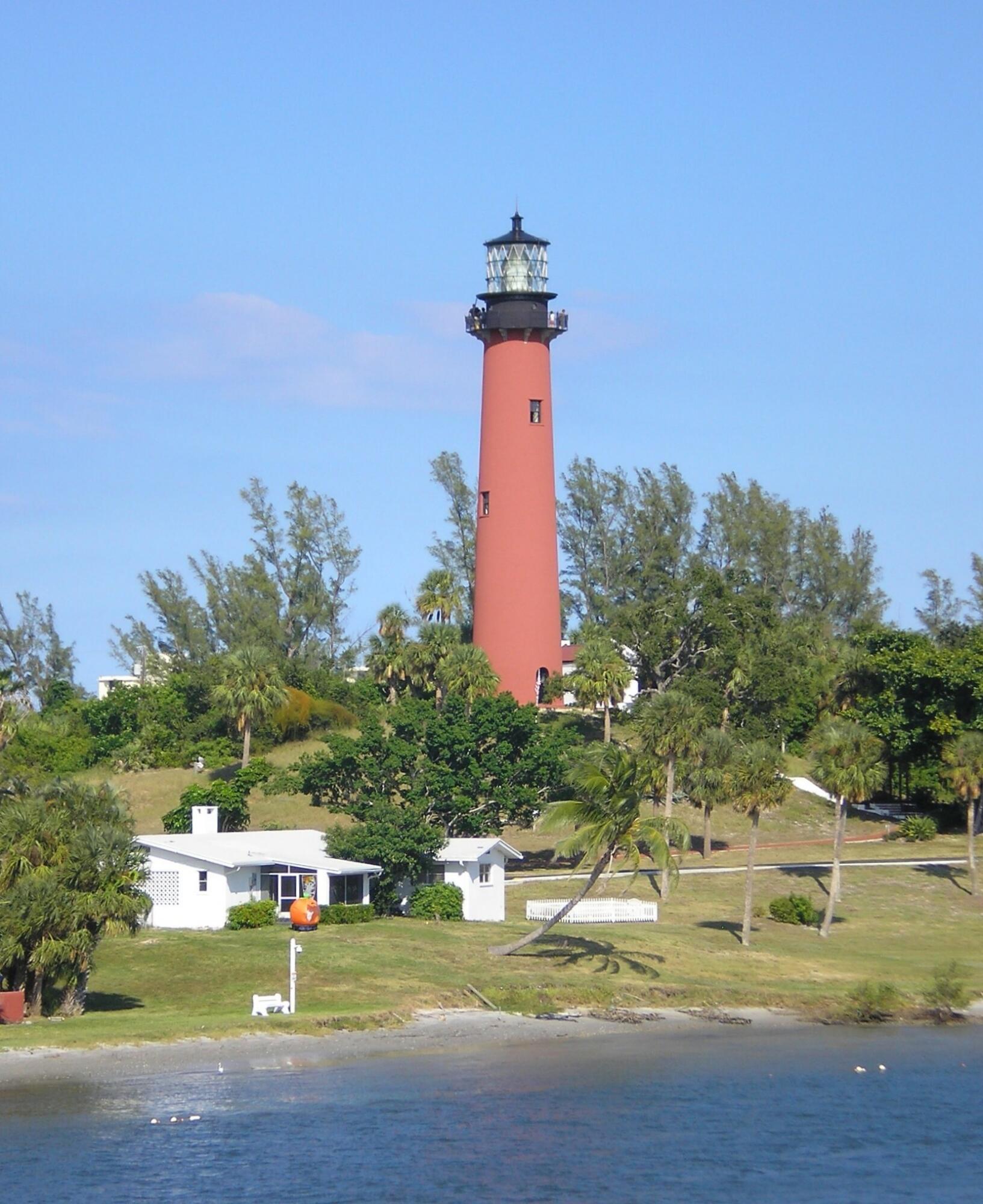 1420 Ocean Way, Unit 14C Jupiter, FL 33477 - Photo 39 of 41 a swimming pool with trees in the background