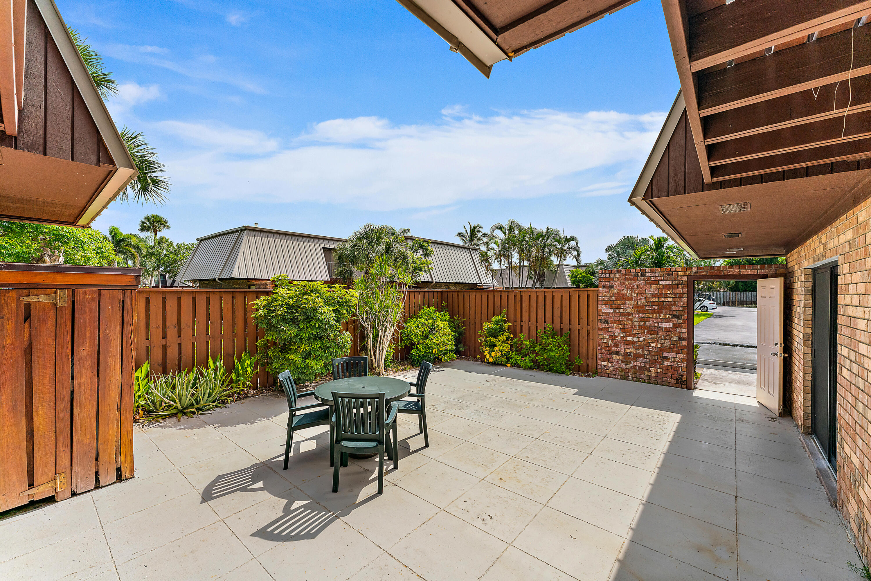 1420 Ocean Way, Unit 14C Jupiter, FL 33477 - Photo 5 of 41 a patio with table and chairs
