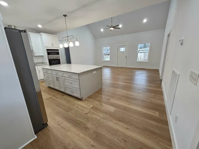 a bathroom with a granite countertop toilet sink and mirror