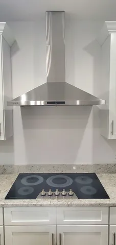 a bathroom with a granite countertop sink a toilet and shower