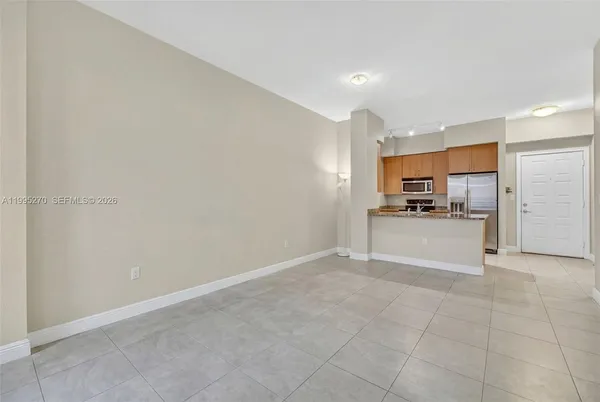 a view of kitchen with refrigerator and window