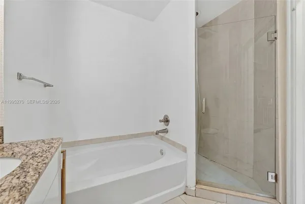 a bathroom with a tub and shower