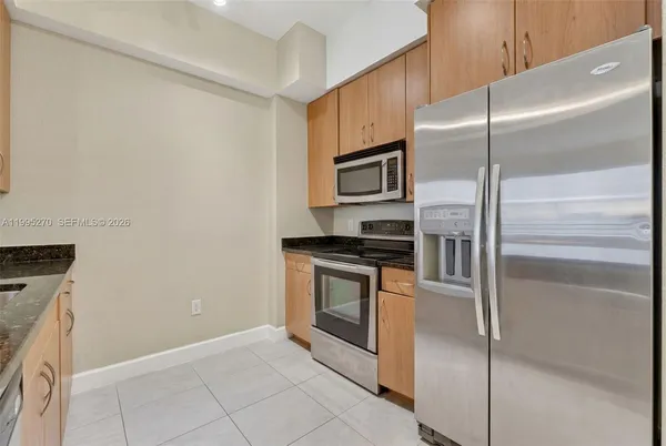 a kitchen with a refrigerator stove and microwave