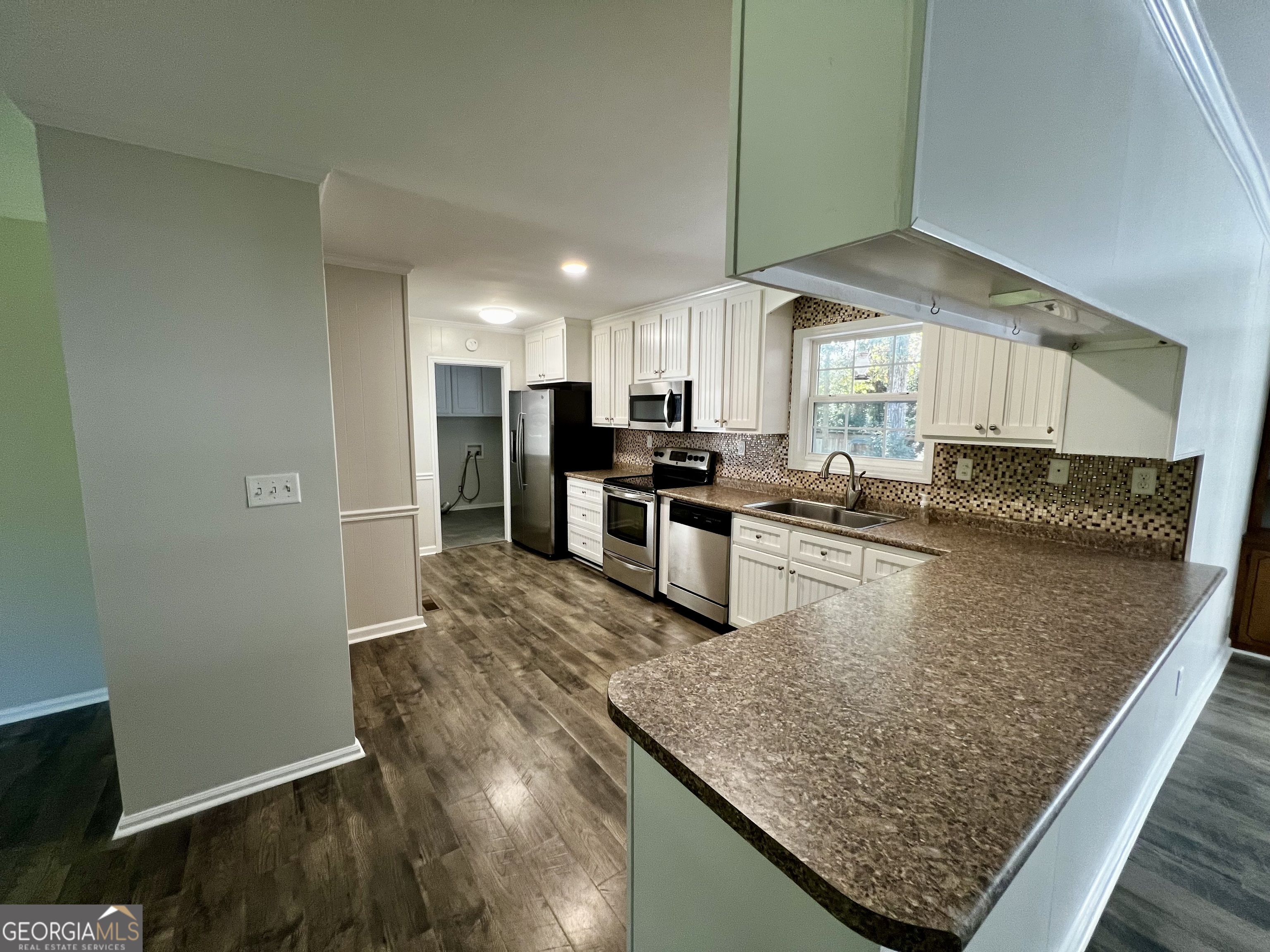 203 Smithfield Road Dublin, GA 31021 - Photo 12 of 44 a kitchen with stainless steel appliances granite countertop a sink stove and refrigerator