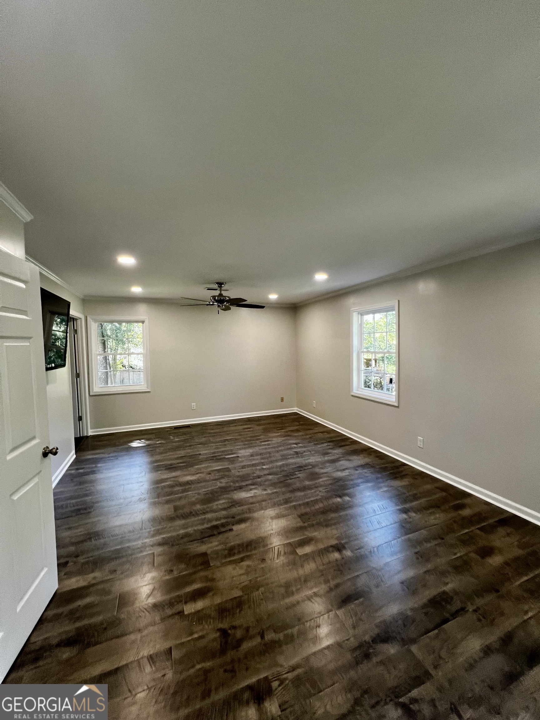 203 Smithfield Road Dublin, GA 31021 - Photo 22 of 44 an empty room with wooden floor and windows