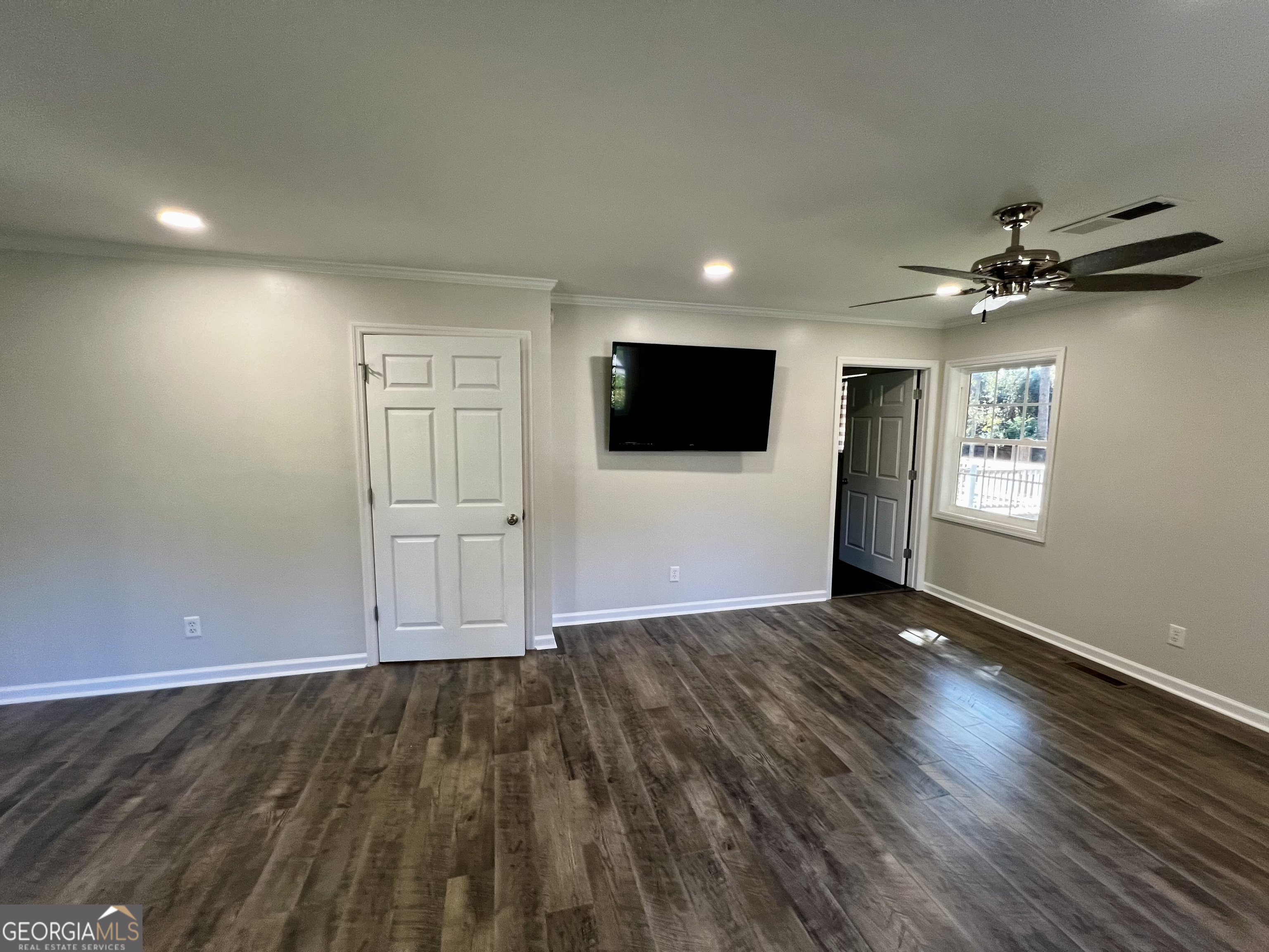 203 Smithfield Road Dublin, GA 31021 - Photo 23 of 44 an empty room with wooden floor and windows