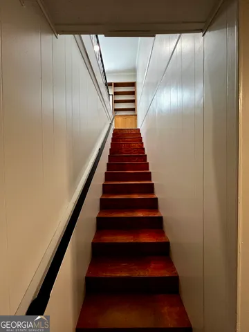 a spacious bathroom with a granite countertop sink and a mirror