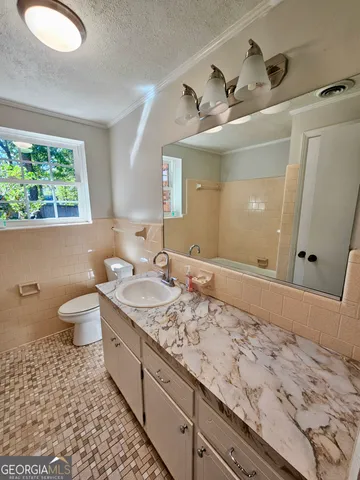a bathroom with a tub a sink and a shower