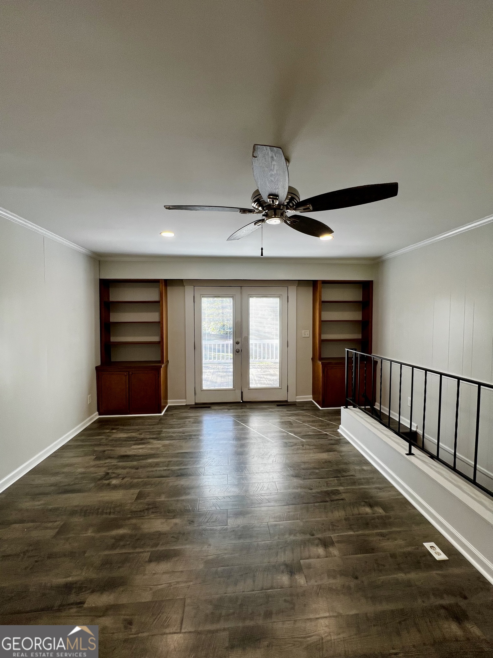 203 Smithfield Road Dublin, GA 31021 - Photo 7 of 44 a view of an empty room with window and wooden floor