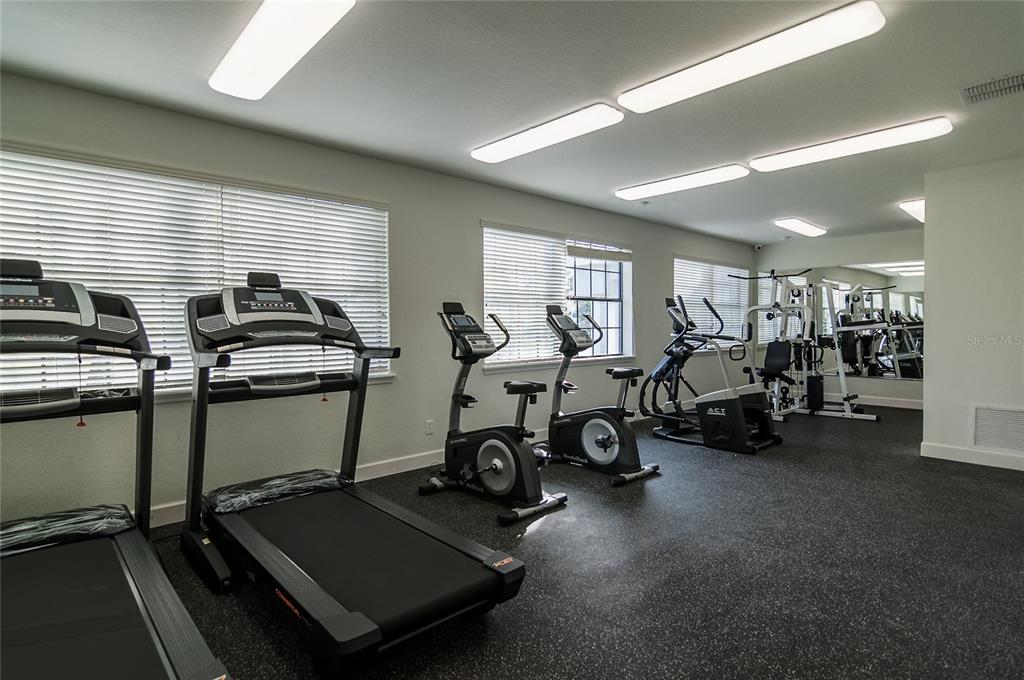 2323 McCoy Road, Unit 711 Orlando, FL 32809 - Photo 12 of 14 a room with gym equipment and a large window