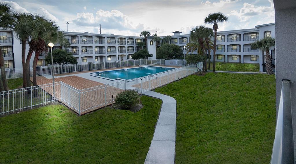 2323 McCoy Road, Unit 711 Orlando, FL 32809 - Photo 13 of 14 a view of a house with a yard and sitting area