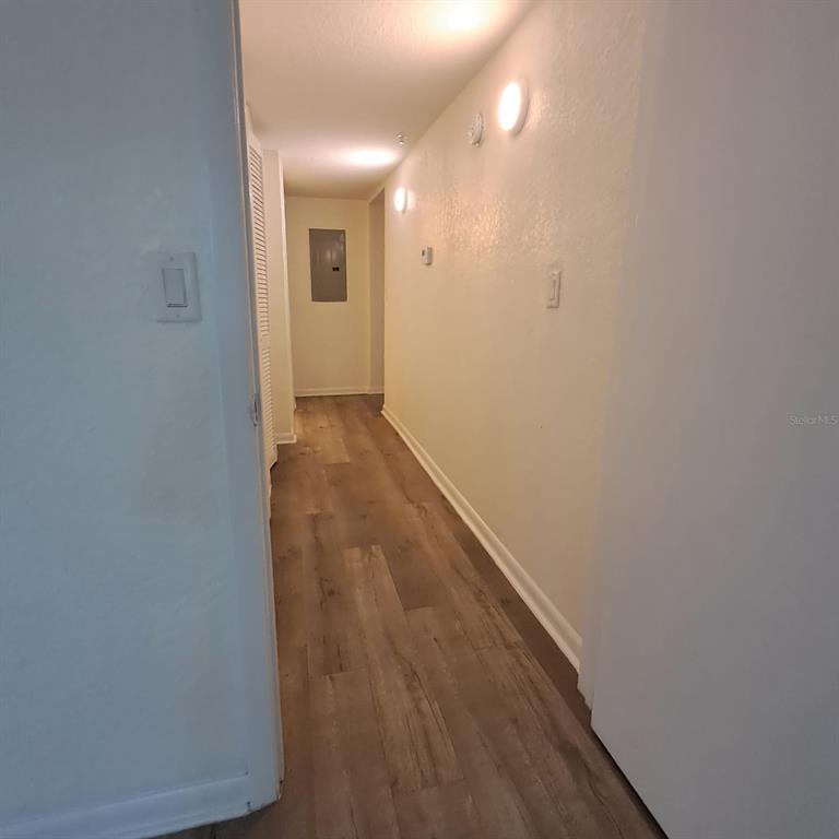 2323 McCoy Road, Unit 711 Orlando, FL 32809 - Photo 4 of 14 a view of a hallway with wooden floor