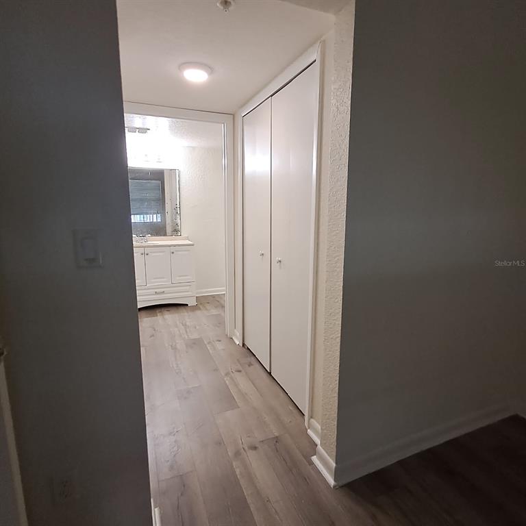 2323 McCoy Road, Unit 711 Orlando, FL 32809 - Photo 7 of 14 a view of a hallway with wooden floor