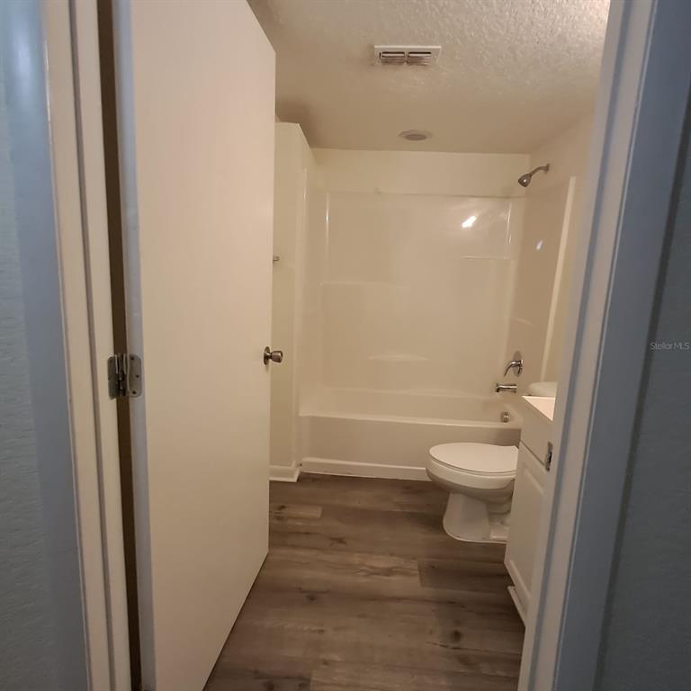 2323 McCoy Road, Unit 711 Orlando, FL 32809 - Photo 8 of 14 a bathroom with a toilet and a shower