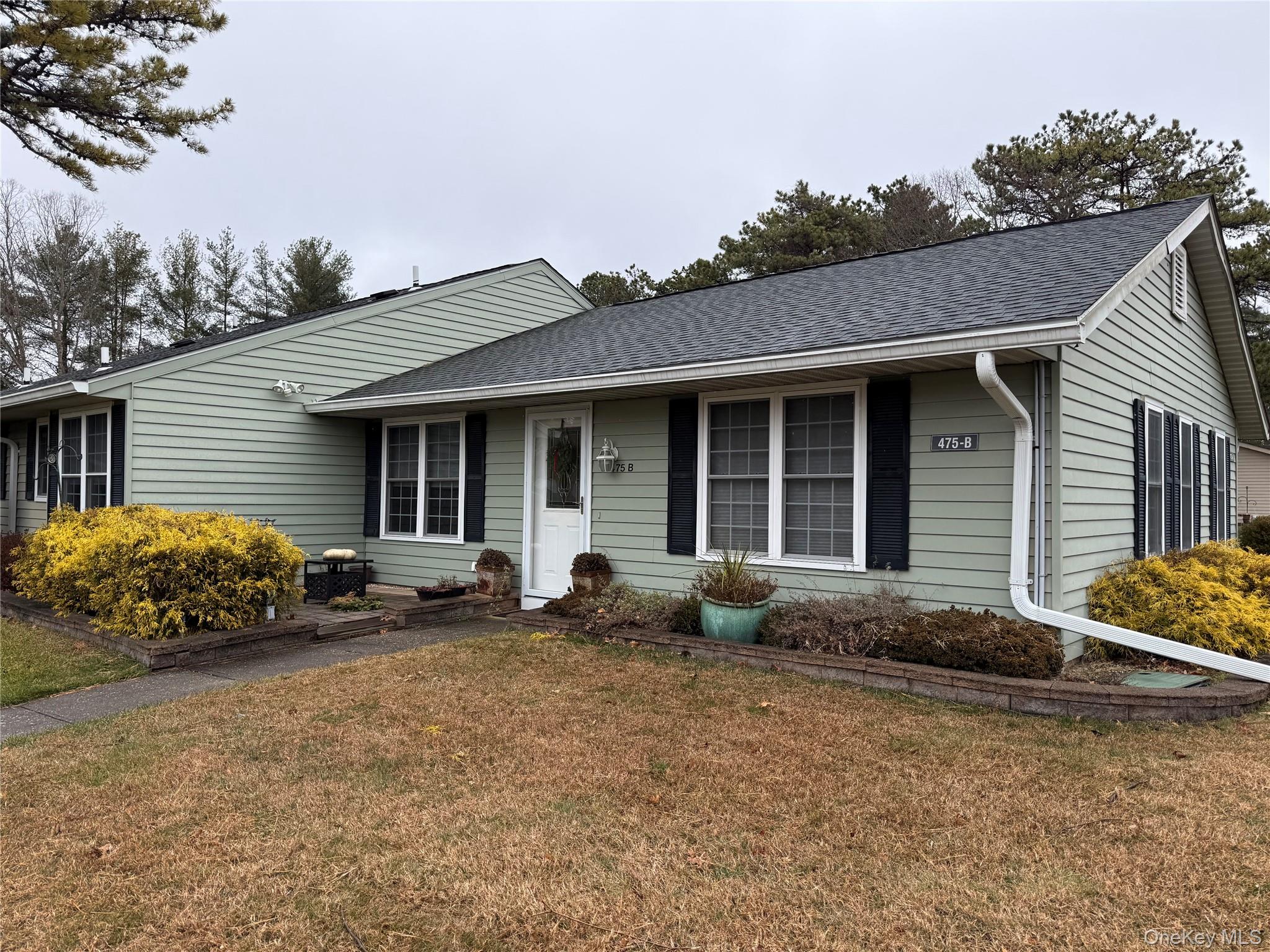 a front view of a house with yard and barbeque oven