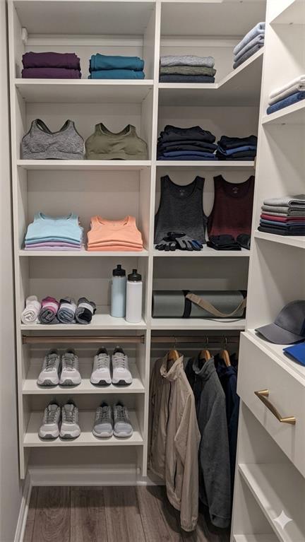 4830 Spangle Court Cumming, GA 30028 - Photo 15 of 18 a view of walk in closet with clothes and shoes