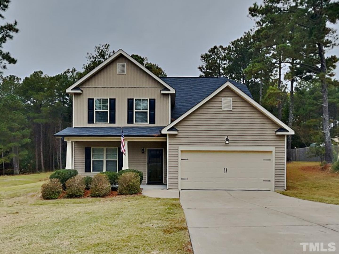 118 Tilden Howington Drive Lillington, NC 27546 - Photo 1 of 17 a front view of a house with a yard and garage