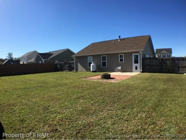 a front view of house with yard and mountain view in back