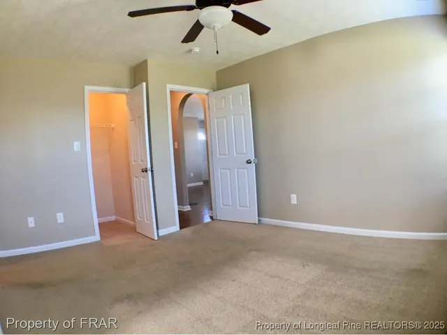 a view of a room with a ceiling fan
