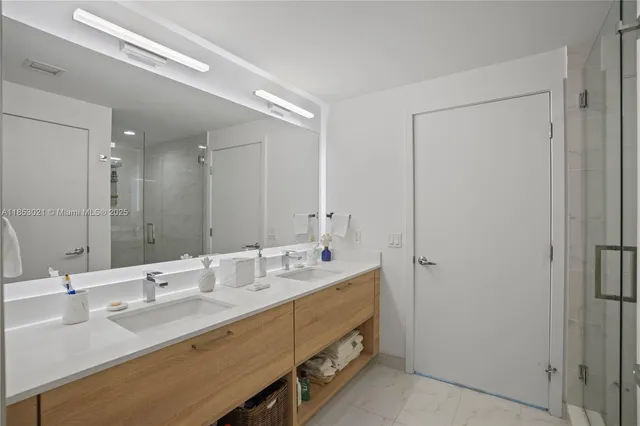 a bathroom with a sink double vanity and a mirror