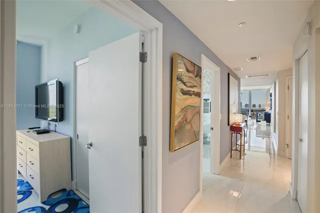 a room with a bed and a flat screen tv