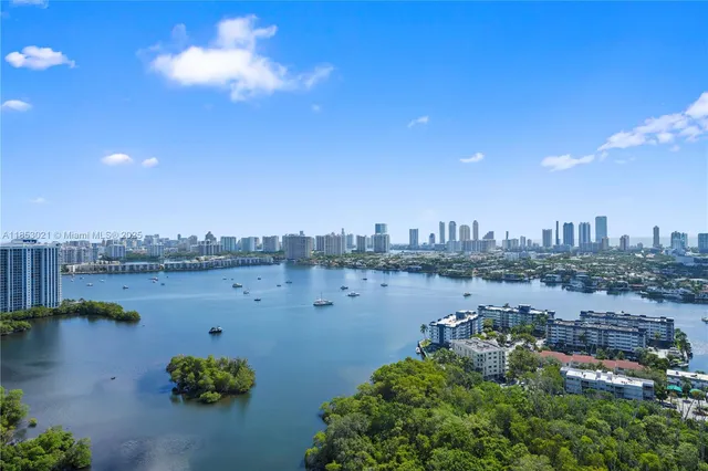 a view of a living room with furniture and floor to ceiling windows
