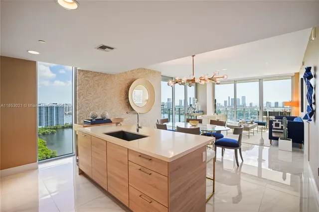 a kitchen with a sink a counter top space and stainless steel appliances