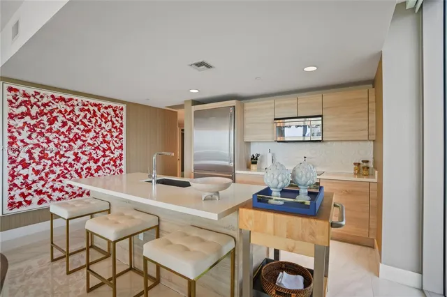 a dining room with furniture a large window and a chandelier