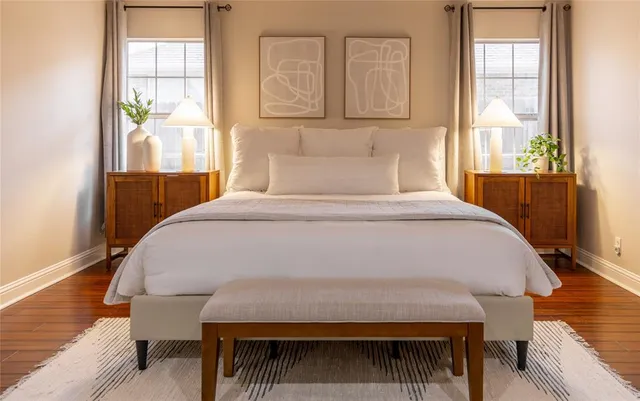 a bed sitting in a bedroom next to a window