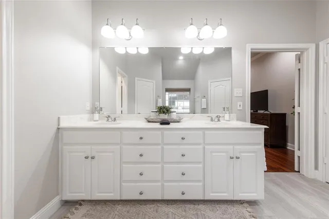 a bathroom with a sink double vanity and a mirror
