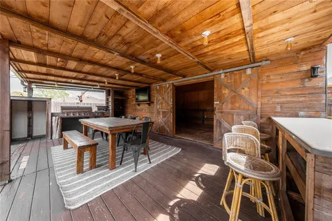 a view of a patio with table and chairs with wooden floor