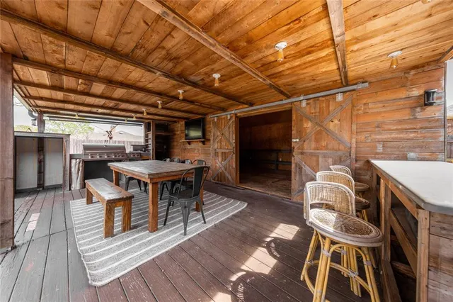 a view of a patio with table and chairs with wooden floor