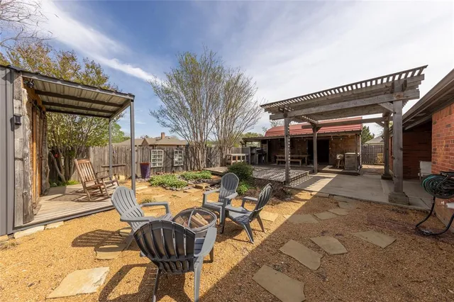 a view of a patio with table and chairs and floor to ceiling window
